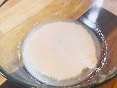 Foamy yeast for Bacon Maple Cinnamon Rolls in glass bowl
