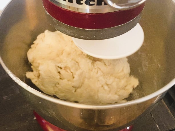 mixing Bacon Maple Cinnamon Rolls dough in stand mixer