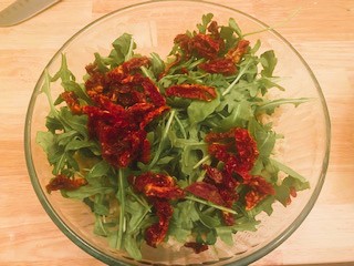 Mediterranean couscous salad in glass bowl