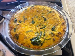 Sausage Potato Frittata in glass baking dish cooling on stove top